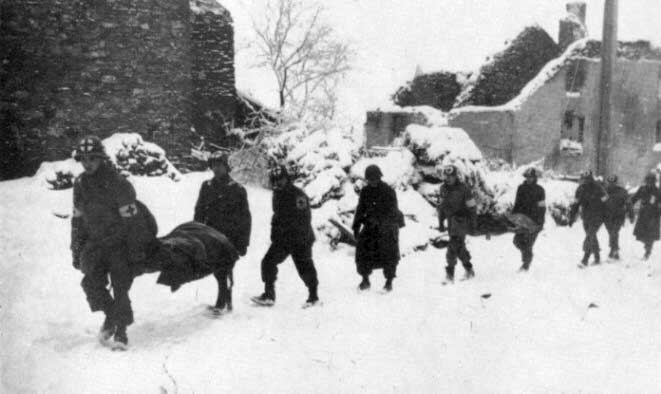 Medics of Comapny A, 110th Medical Battalion evacuate wounded at Lutrebois, Belgium