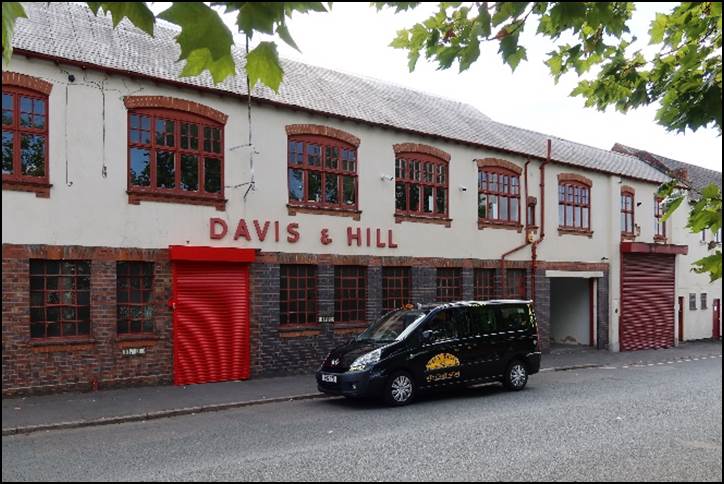 A black car parked in front of a building

Description automatically generated with medium confidence