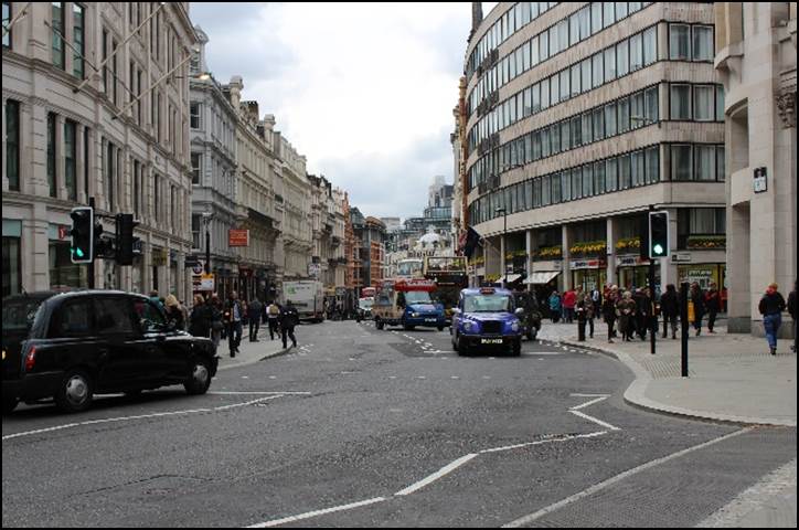 A busy street with cars and people

Description automatically generated with low confidence