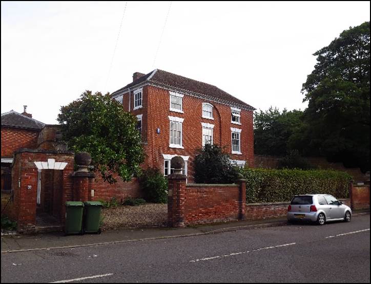 A brick building with a car parked in front of it

Description automatically generated with low confidence