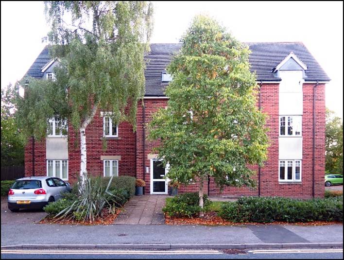 A brick house with a tree in front of it

Description automatically generated with low confidence