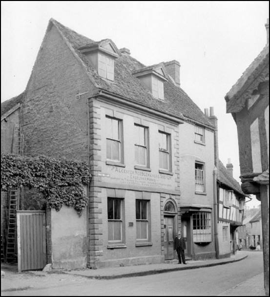 A vintage photo of an old building

Description automatically generated