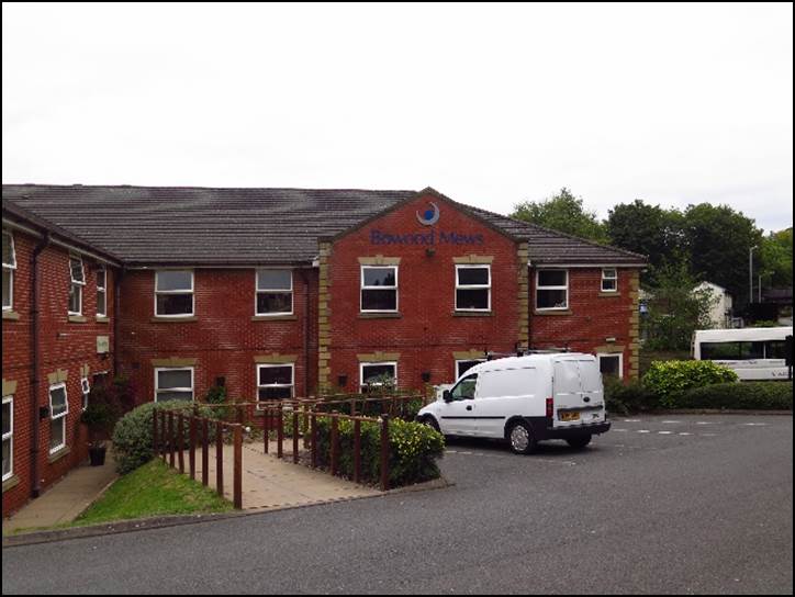 A red brick building with a white van parked in front of it

Description automatically generated with medium confidence