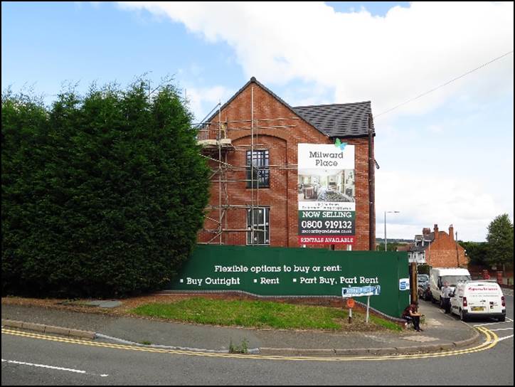 A brick building with a sign on the front

Description automatically generated with low confidence