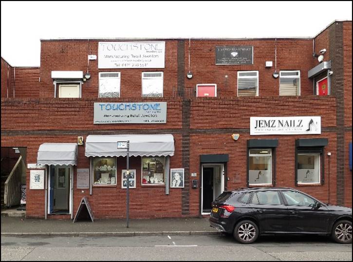 A car parked in front of a brick building

Description automatically generated with medium confidence