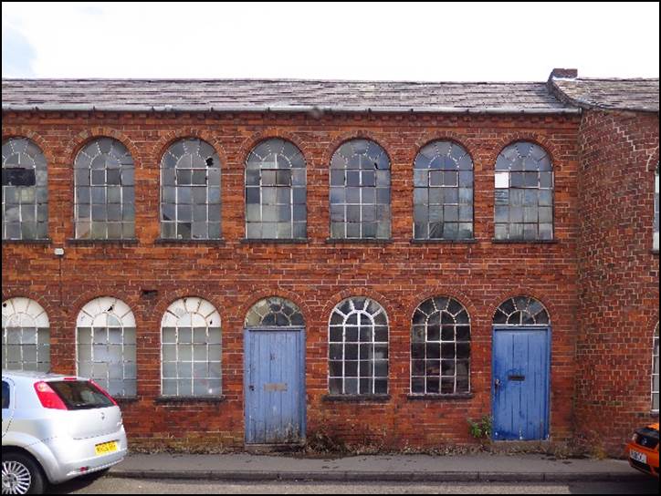 A picture containing building, outdoor, brick, parked

Description automatically generated