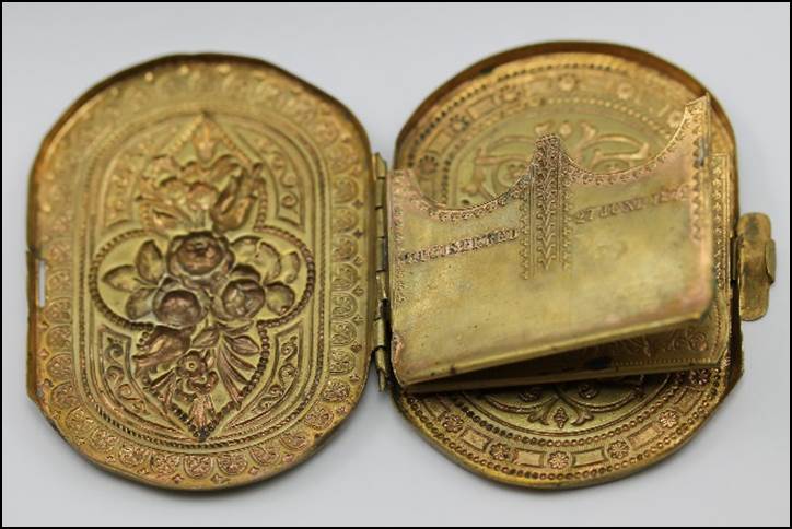 A picture containing coin, locket

Description automatically generated