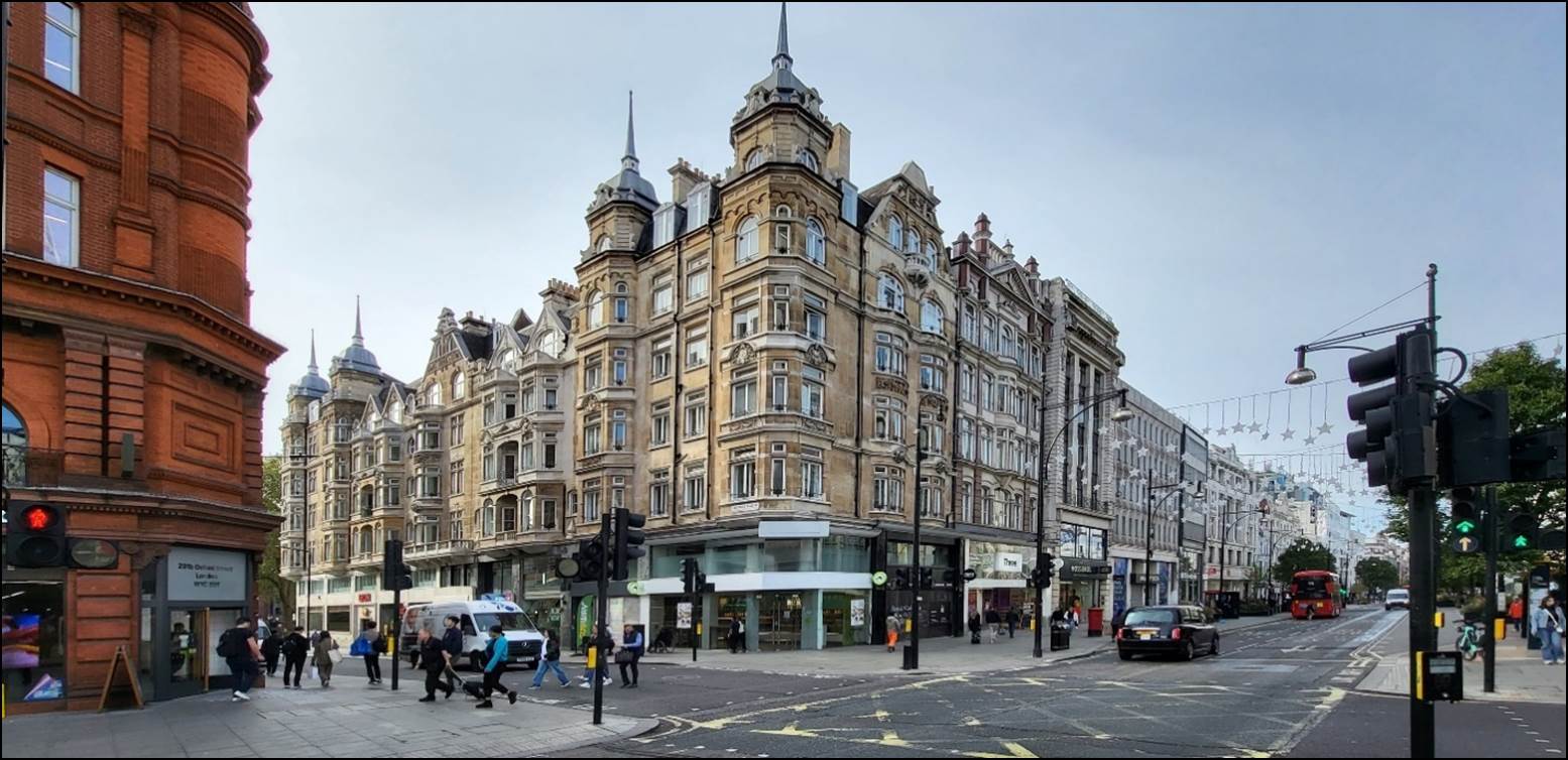 A building with many windows and a street corner

Description automatically generated