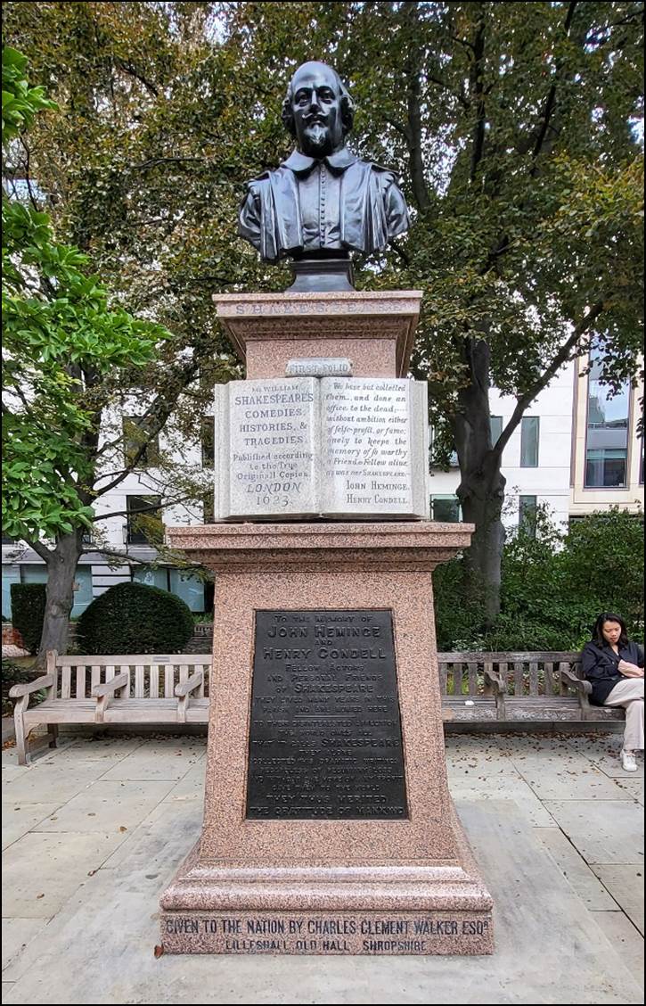 A statue of a person with a book on a pedestal

Description automatically generated