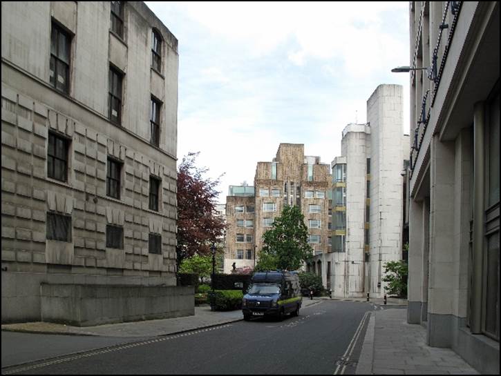 A car driving down a street between buildings

Description automatically generated with low confidence