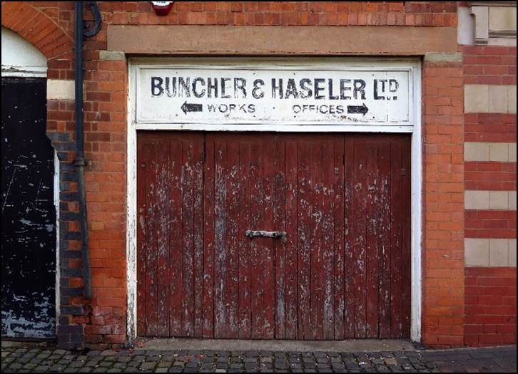 A sign in front of a brick building

Description automatically generated