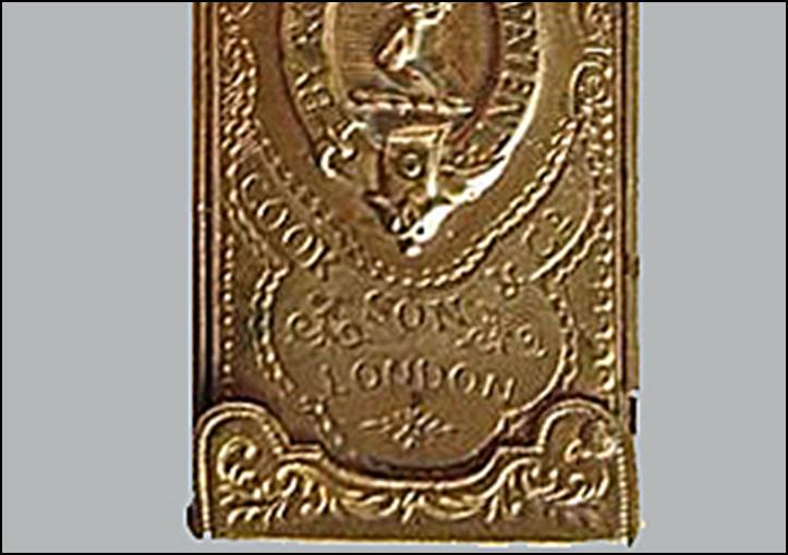 A gold rectangular object with a picture on it

Description automatically generated