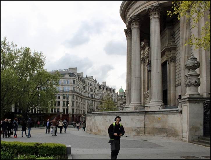 A person running in front of a building

Description automatically generated