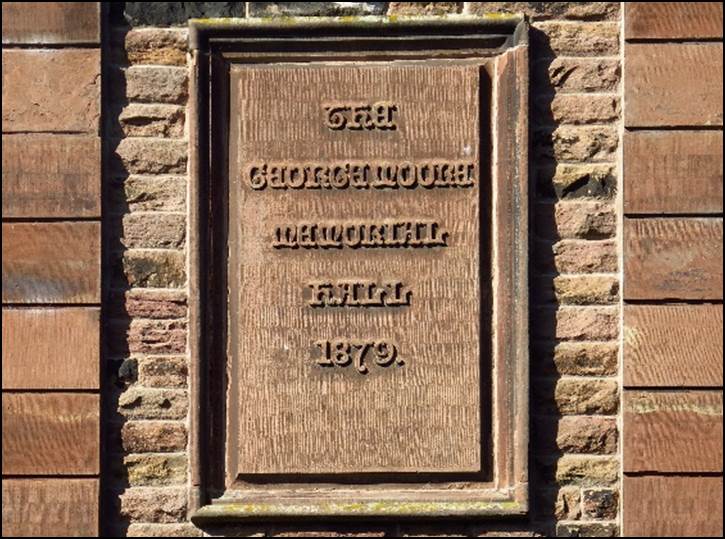 A plaque on a brick wall

Description automatically generated with medium confidence