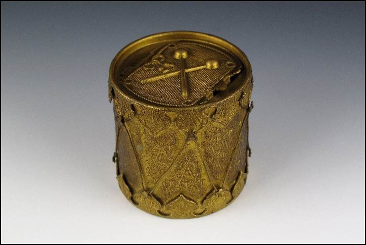 A gold cylinder with a compass

Description automatically generated