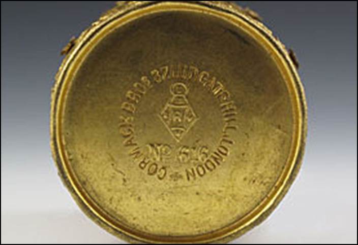 A close-up of a gold container

Description automatically generated