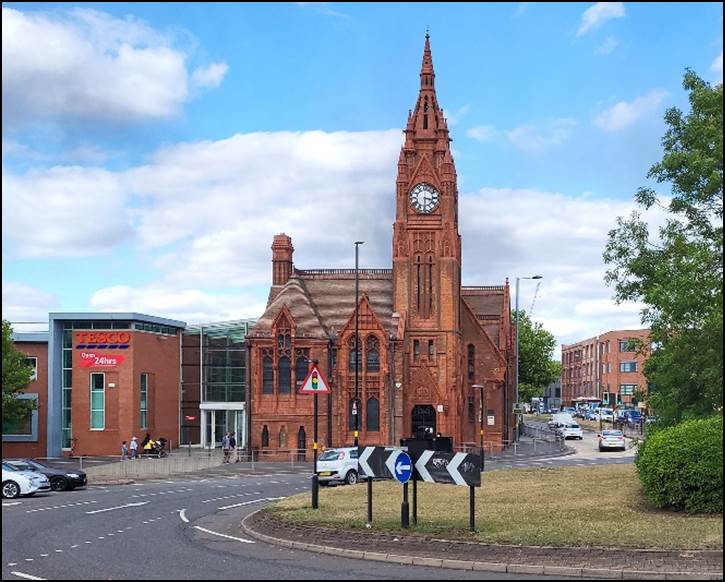 A clock tower in a city

Description automatically generated with medium confidence