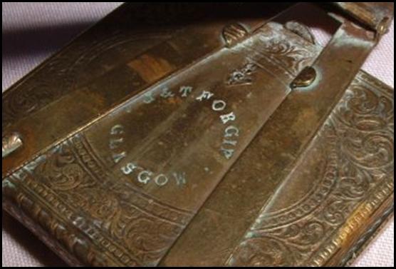 A close-up of a brass book

Description automatically generated