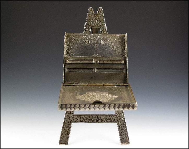 A small metal easel with an open lid

Description automatically generated