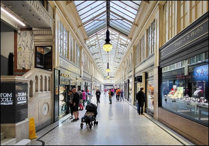 A group of people walking in a shopping mall

Description automatically generated