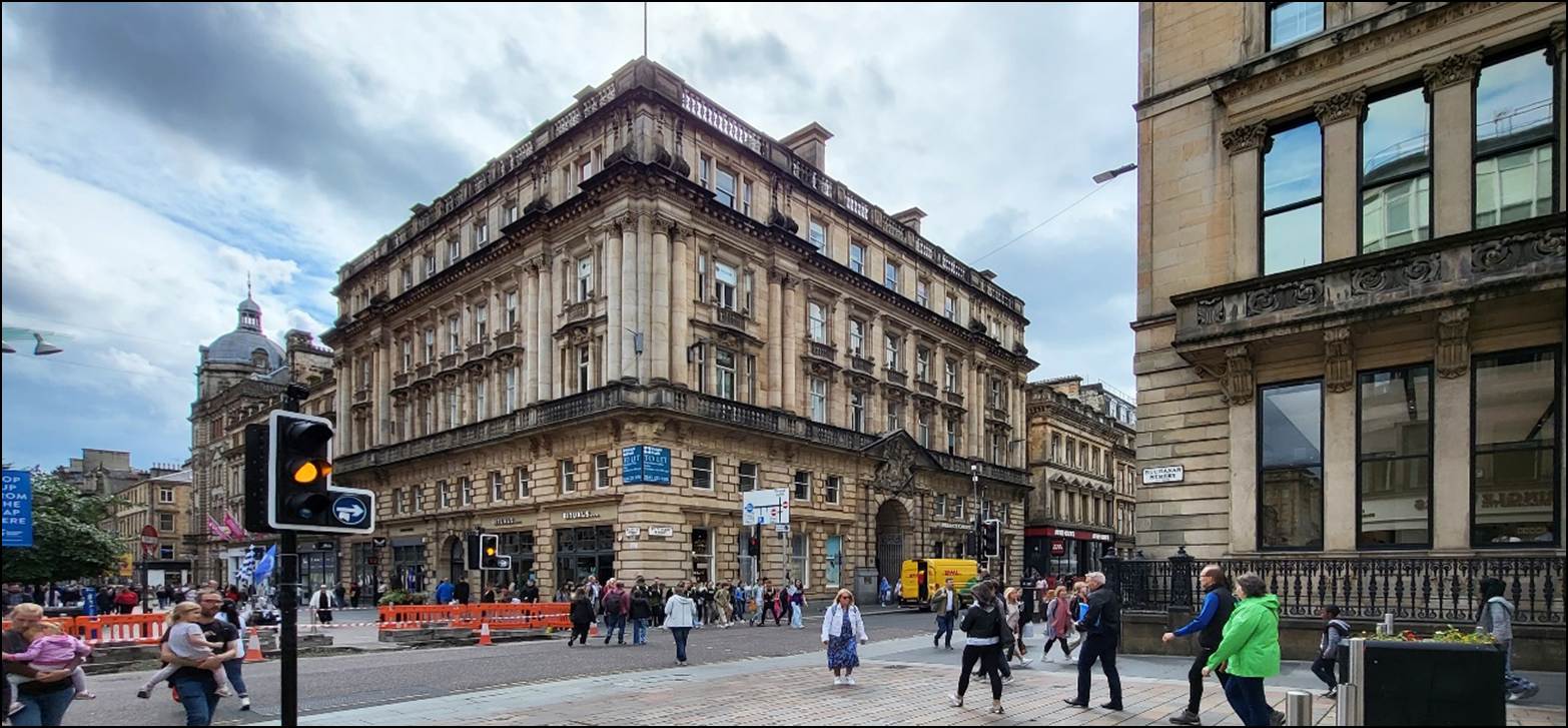 A group of people walking in a city

Description automatically generated