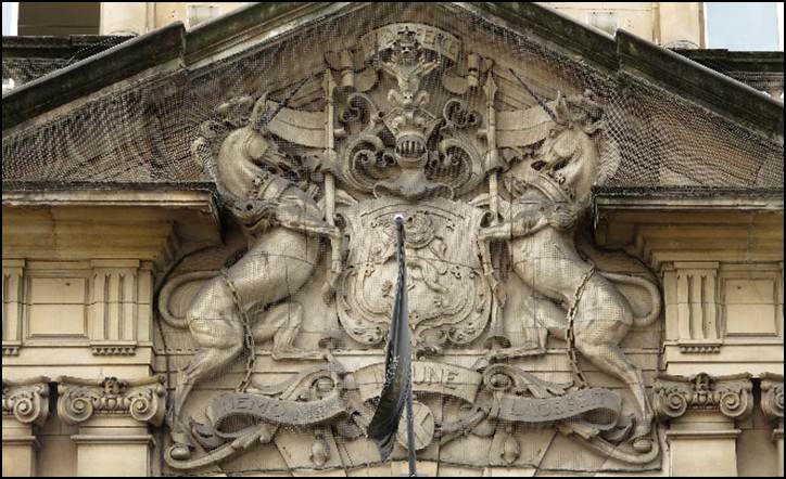 A stone building with a shield and a sword

Description automatically generated with medium confidence