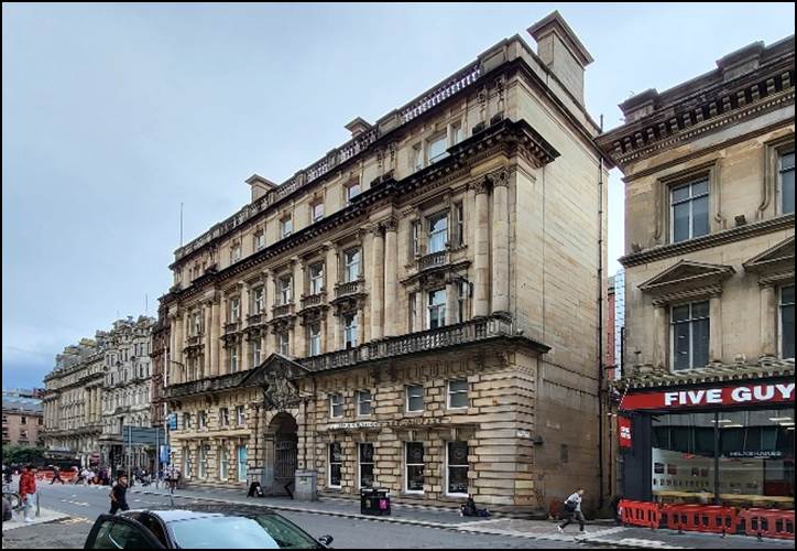 A building next to a street

Description automatically generated