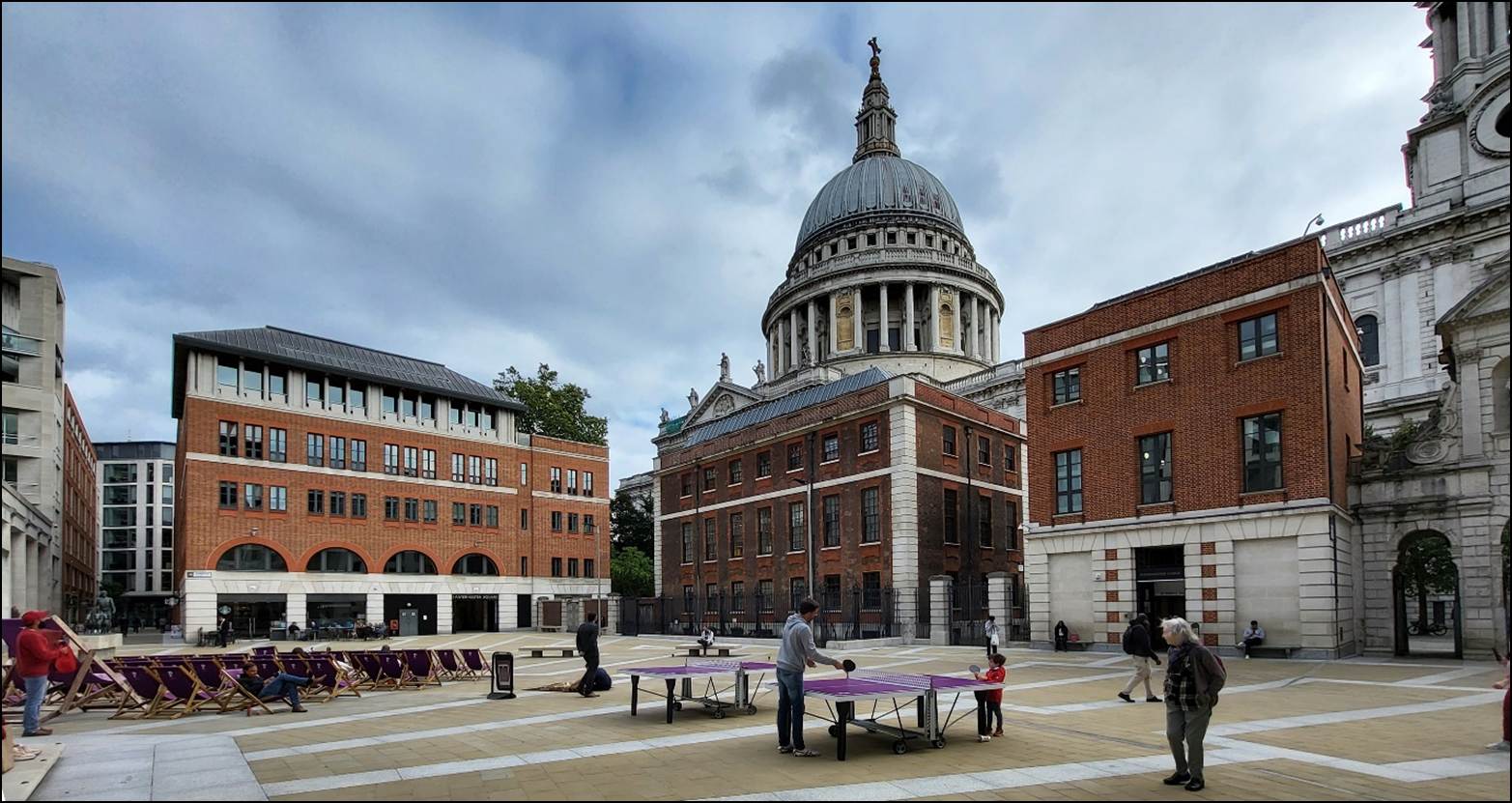 A group of people playing table in a courtyard

Description automatically generated