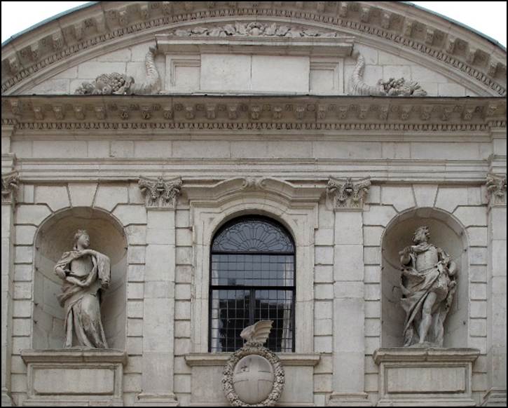 A stone building with statues on the front

Description automatically generated