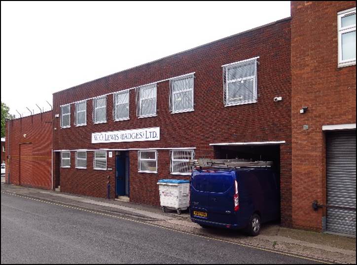 A car parked in front of a brick building

Description automatically generated