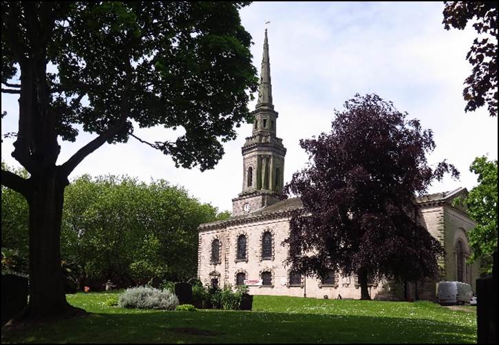 A large clock tower in the middle of a park

Description automatically generated