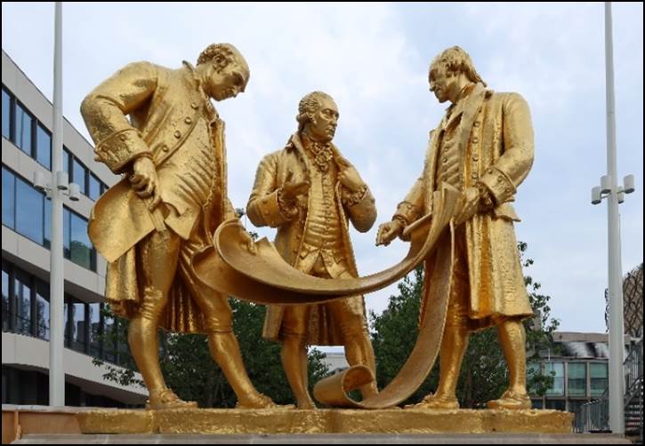 A statue of men in gold

Description automatically generated