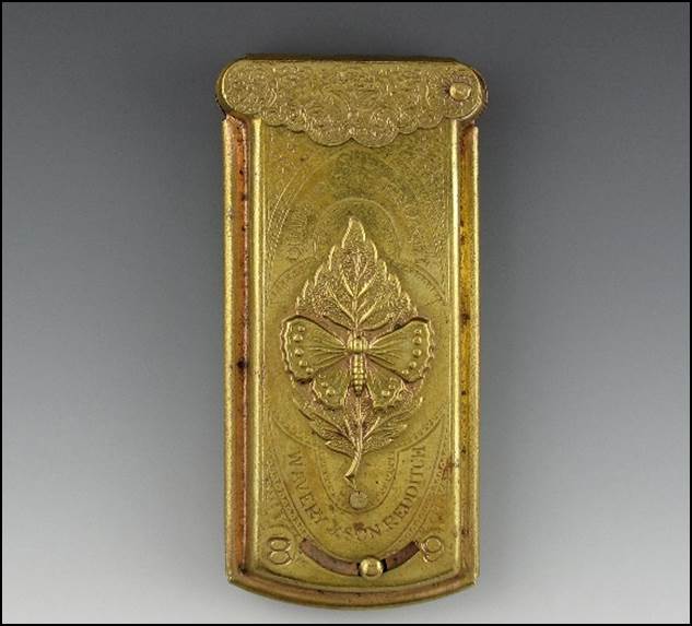 A gold rectangular object with a design on it

Description automatically generated