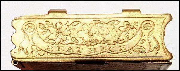 A gold plate with text on it

Description automatically generated