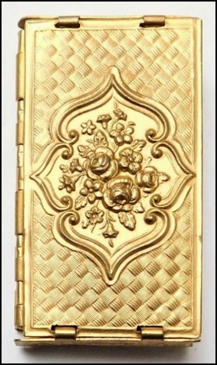 A gold rectangular object with flowers on it

Description automatically generated