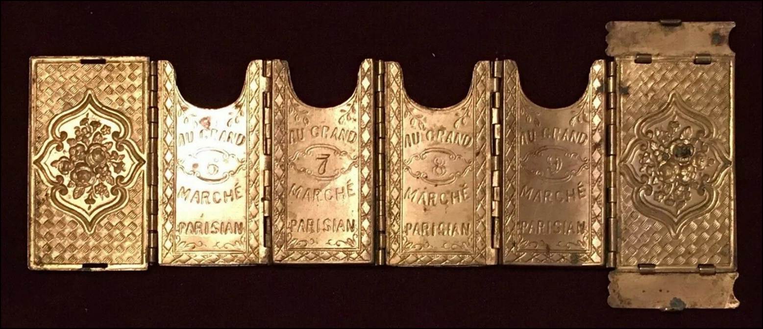 A row of gold metal objects

Description automatically generated