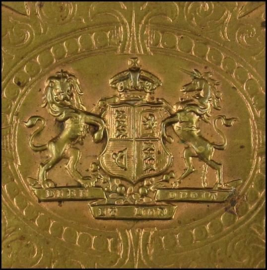 A gold colored square object

Description automatically generated