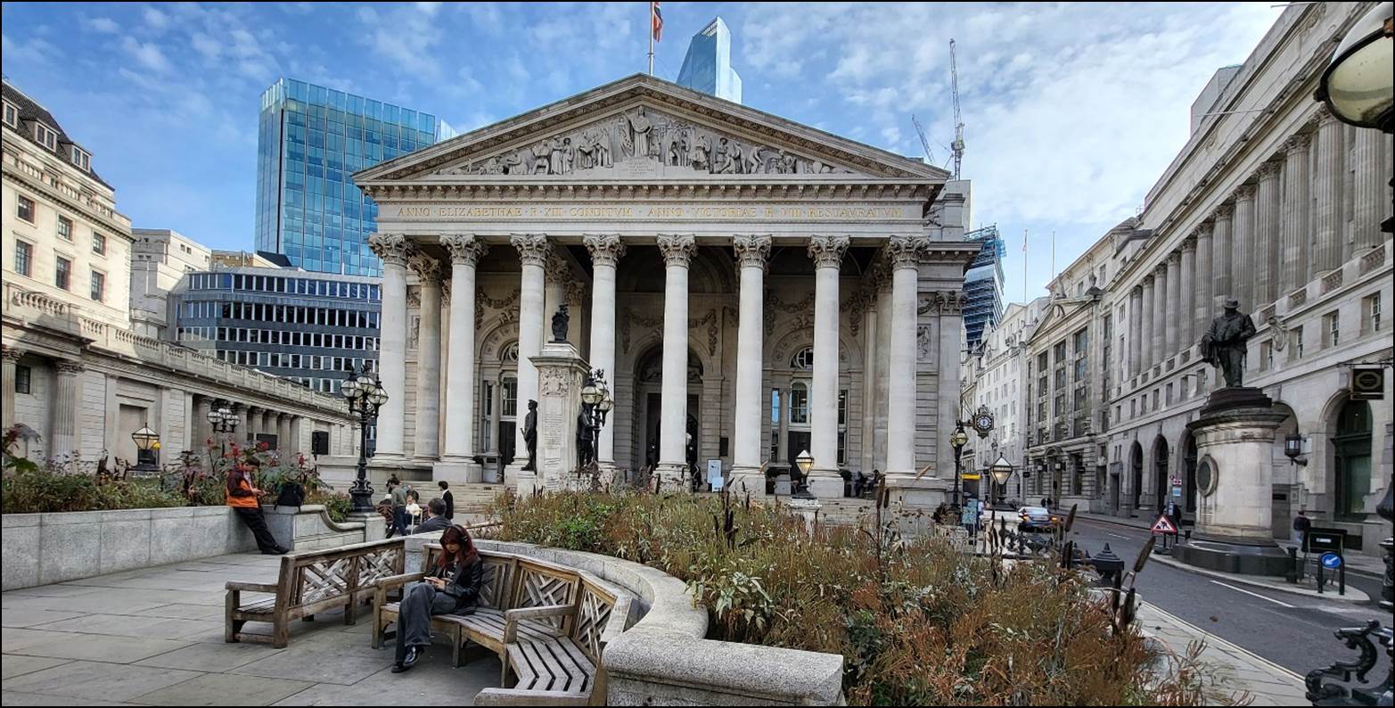 Royal Exchange, London with columns and people sitting on benches

Description automatically generated