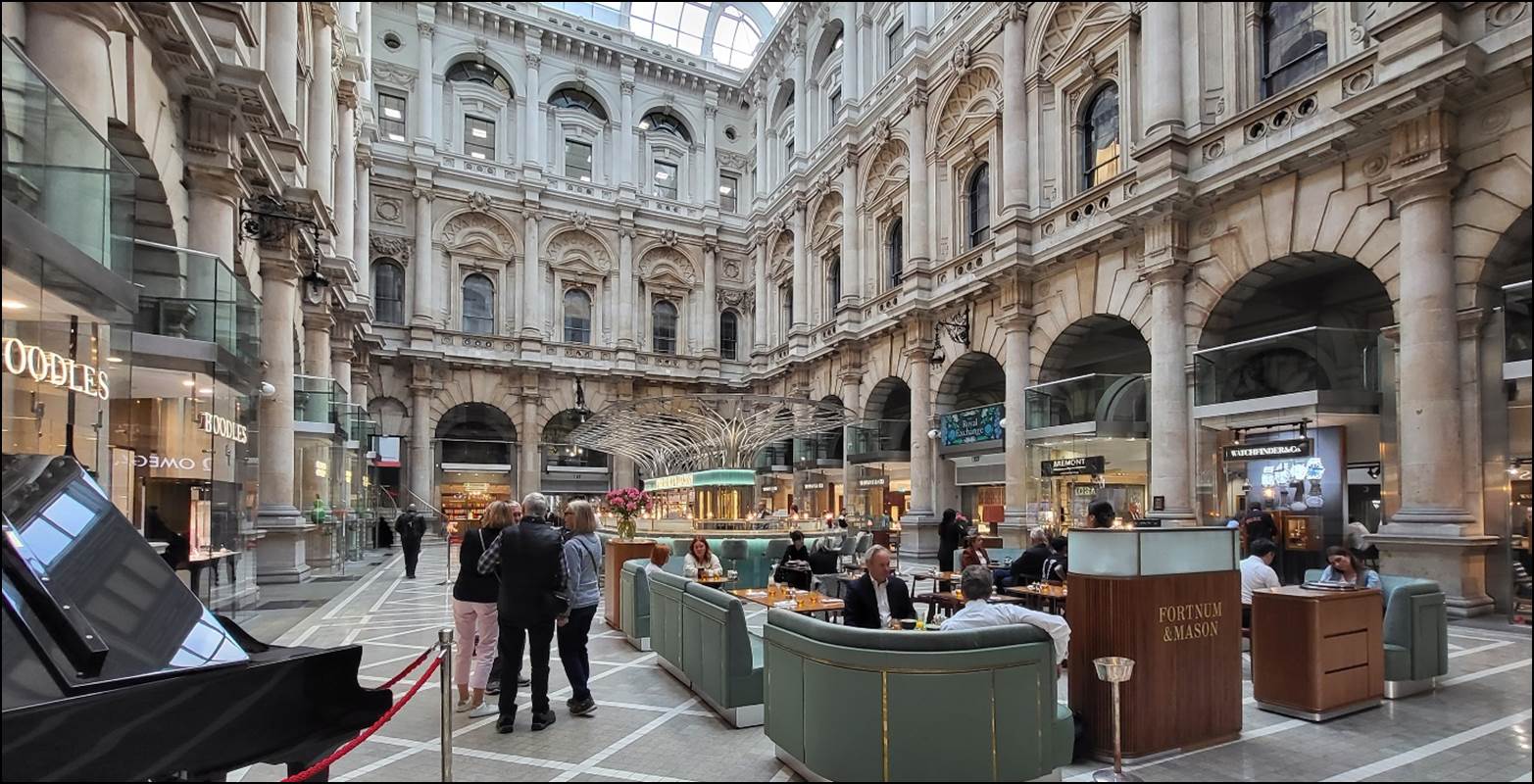 People inside of Royal Exchange, London with many people

Description automatically generated