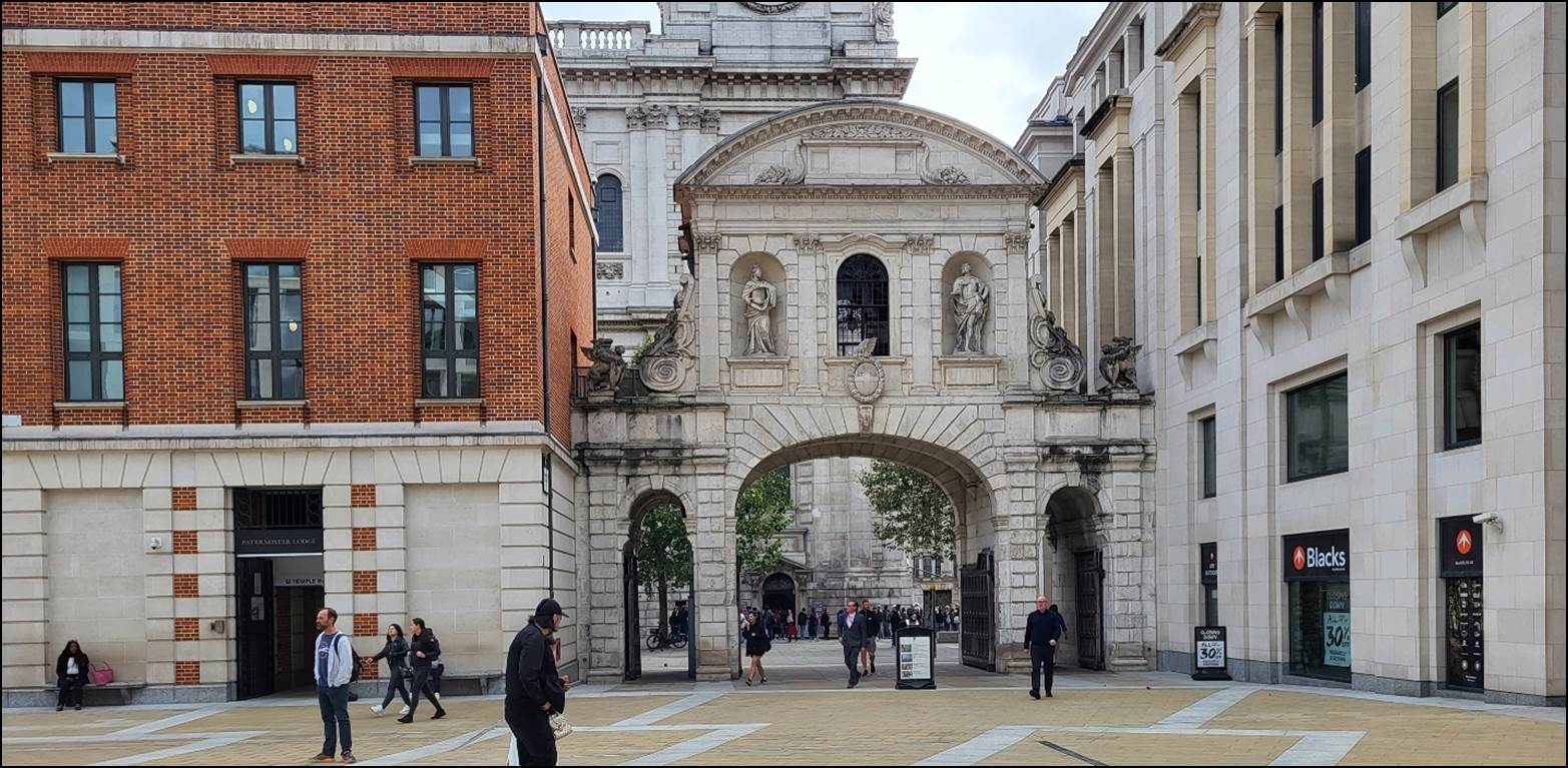 A group of people walking in front of a building

Description automatically generated