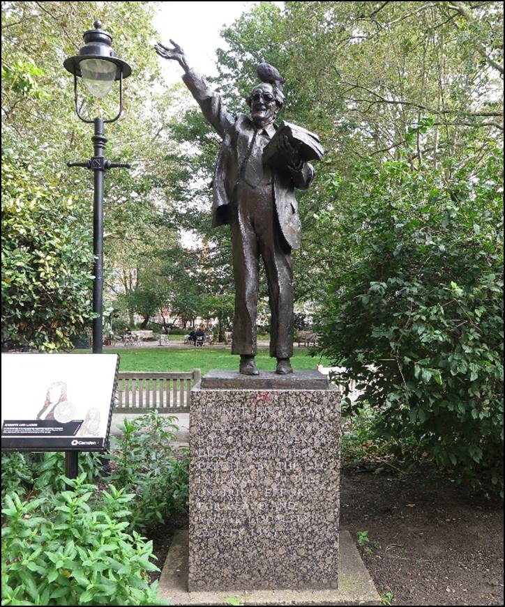 A statue of a person holding a newspaper

Description automatically generated