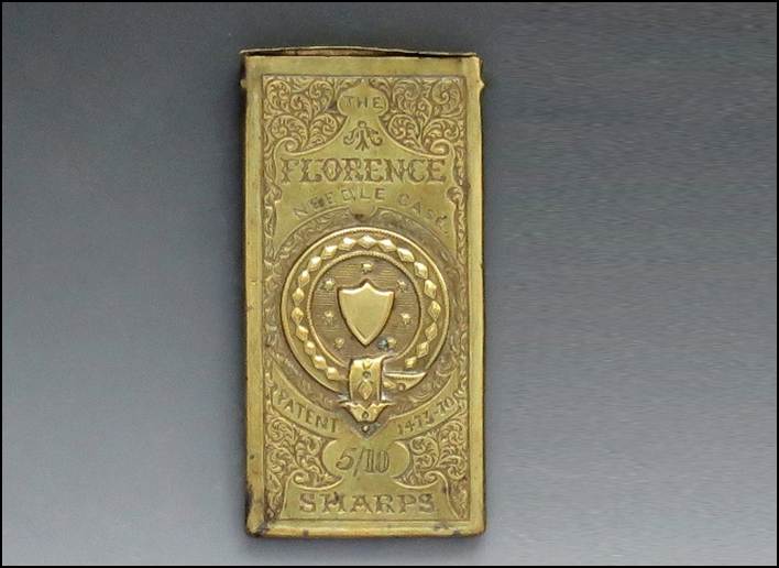 A gold rectangular object with a shield and a shield on it

Description automatically generated