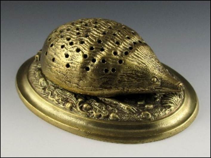 A gold object with holes on it

Description automatically generated