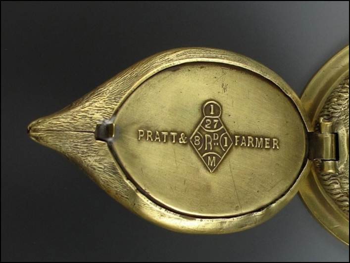 A close-up of an antique brass object

Description automatically generated