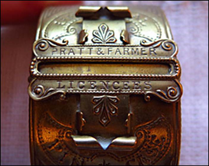 A close-up of a brass bracelet

Description automatically generated