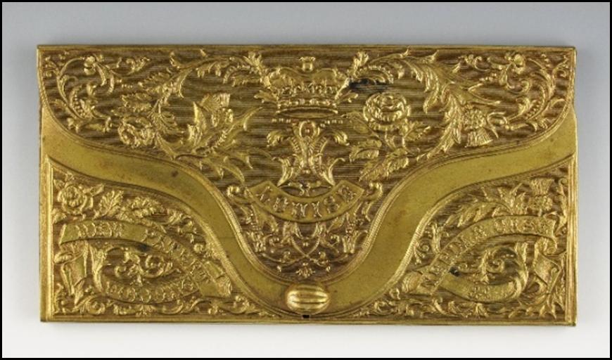 A gold rectangular object with a design

Description automatically generated