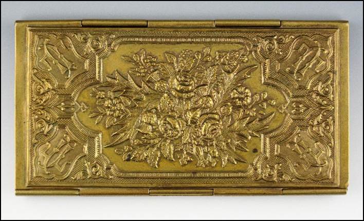 A gold rectangular object with a design

Description automatically generated