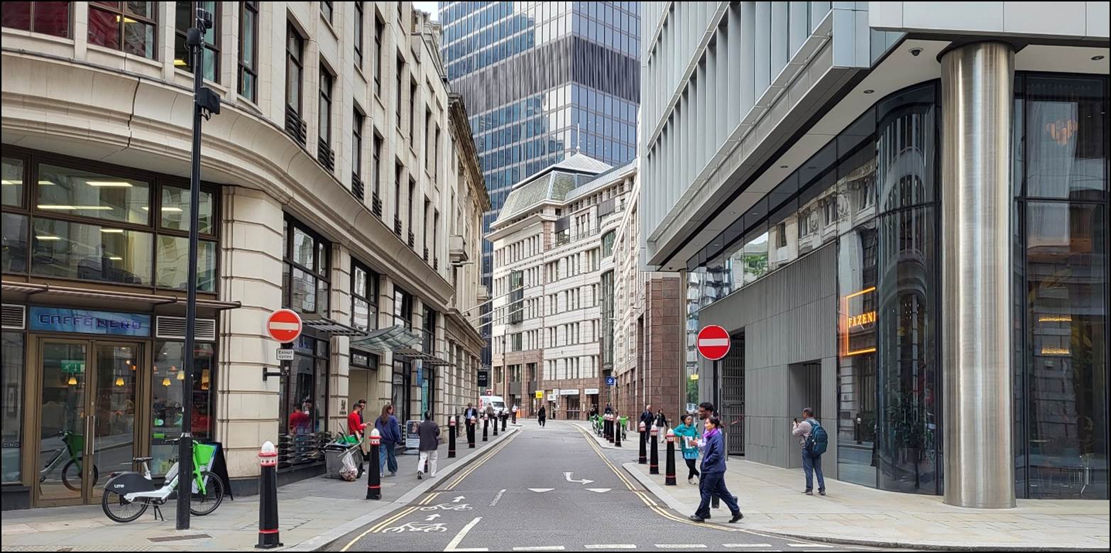 A street with people walking on it

Description automatically generated