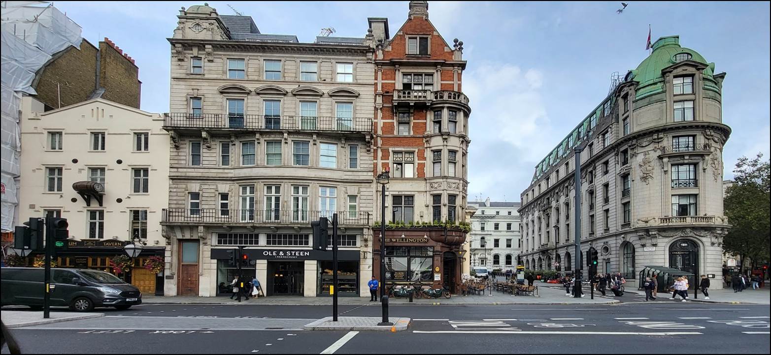 A street with a building in the background

Description automatically generated