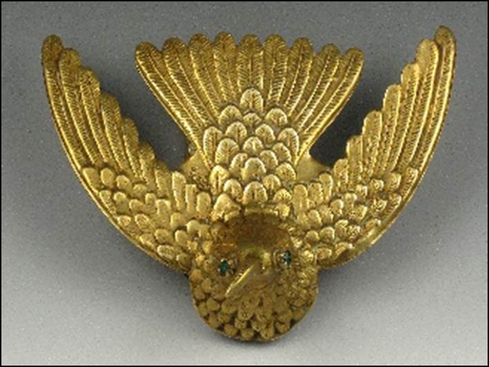 A gold eagle with green eyes

Description automatically generated